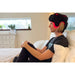 Person wearing a black Fringe Red Light Therapy Head Wrap with LED lights in a bedroom setting.