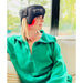 Person wearing a black Fringe Red Light Therapy Head Wrap, sitting on a couch.