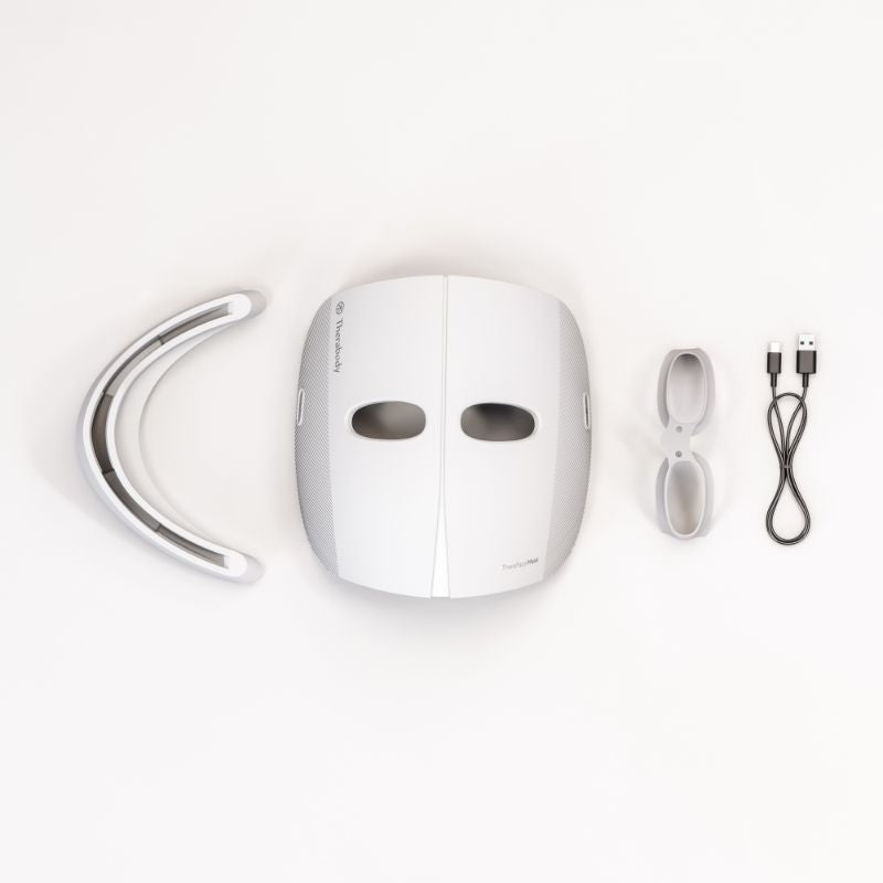 White Therabody Theraface LED Mask with attachments.